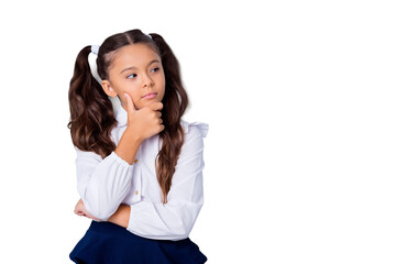 Nice cute tender adorable lovely stylish girl with curly pigtails in white formal blouse shirt and blue skirt, showing thoughtful gesture, hand to chin, copy-space. Isolated over grey background