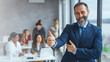 © Dragana Gordic - Cheerful businessman thumbs up posing and smiling at camera.  Portrait of happy business man looking at camera with copy space. Satisfied proud man feeling confident in a modern office.