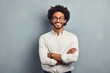 © Markus Schröder - Portrait of a cheerful afro-american man in his 20s with arms crossed isolated in minimalist or empty room background