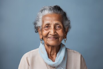Wall Mural - Portrait of a blissful indian elderly woman in her 90s smiling at the camera in minimalist or empty room background
