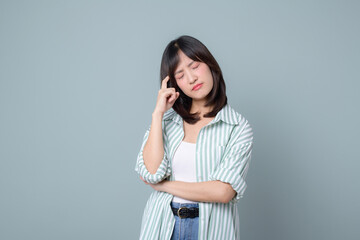 Wall Mural - Lifestyle, asian woman emotions and casual concept. Shy and modest cute clueless girl, smirk, uncertain, having doubts or hesitations, standing pastel green background