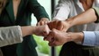 © Marko - Happy motivated young and older generation multiracial business people joining fists, showing support and team spirit together