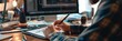 © gunzexx png and bg - Skilled graphic designer draws using a digital pen on a graphic tablet, with two monitors displaying work