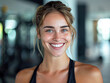 © Kowit - a female athlete with a beaming smile, posing confidently in a gym environment,