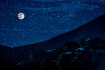 Wall Mural - mountain road through the forest on a full moon night. scenic night landscape of country road at nig