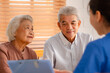 © chokniti - Happy Senior Asian Woman Receives Medical Care at Home, Doctor or Caregiver Nurse Provide Support Assistance, Enhancing Healthcare Services for Elderly Patients Retirement