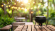 © Ikhou - Photo of A grill on an outdoor wooden table with blurred background of backyard dining area and trees, summer barbecue party concept