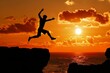 © Eomer2010 - Silhouette of a man jumping between rocks near the sea with an intense orange sunset
