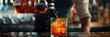 © gunzexx png and bg - A close-up shot of amber-colored whiskey being poured over ice cubes in a short glass, capturing the motion and splash