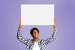 © Prostock-studio - Advertisement. Student holding blank banner with copy space for your text, pink background
