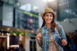 © Drazen - Young happy woman at airport looking at camera.