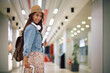 © Drazen - Happy female traveler at  airport looking at camera.