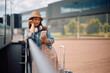 © Drazen - Young distraught woman reading text message on cell phone at airport.
