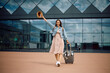 © Drazen - Young woman feeling excited while going on vacation at airport. Copy space.