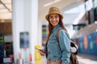 © Drazen - Young happy woman holding passports at airport and looking at camera