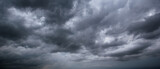 The dark sky with heavy clouds converging and a violent storm before the rain.Bad or moody weather sky and environment. carbon dioxide emissions, greenhouse effect, global warming, climate change.