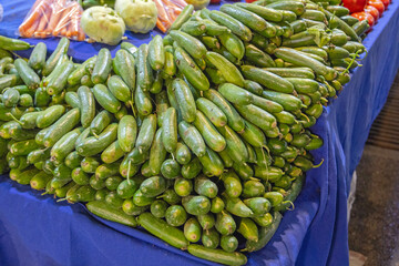 Wall Mural - Big Bunch of Green Cucumbers Vegetables at Farmers Market Stall in Turkey