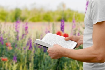 Canvas Print - Open bible in human hands outdoor