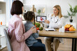 © sofiko14 - Mother with little girl at appointment with family nutritionist. Mature experienced female doctor showing tablet with gastrointestinal tract image for treatment planning to little female child.