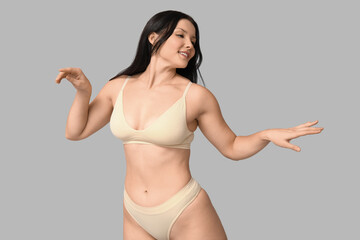 Poster - Body positive young woman in underwear on light background