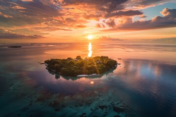 Wall Mural - A small island stands alone in the vast ocean, surrounded by deep blue waters under the golden hues of a setting sun