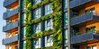 © dinastya - Modern sustainable building with solar panels, vertical garden with green plants.