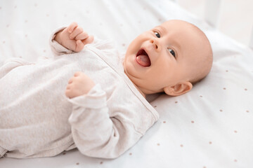 Wall Mural - Cute little baby lying in crib at home