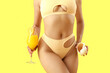 © Pixel-Shot - Attractive young woman in swimsuit with cocktail and seashell on yellow background, closeup