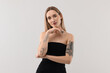 © New Africa - Portrait of beautiful tattooed woman on light background