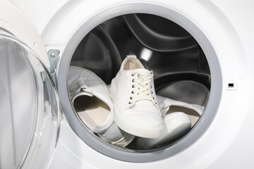 Sticker - Stylish clean sneakers inside modern washing machine