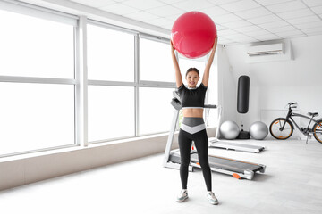 Wall Mural - Sporty Asian woman with fitball in gym
