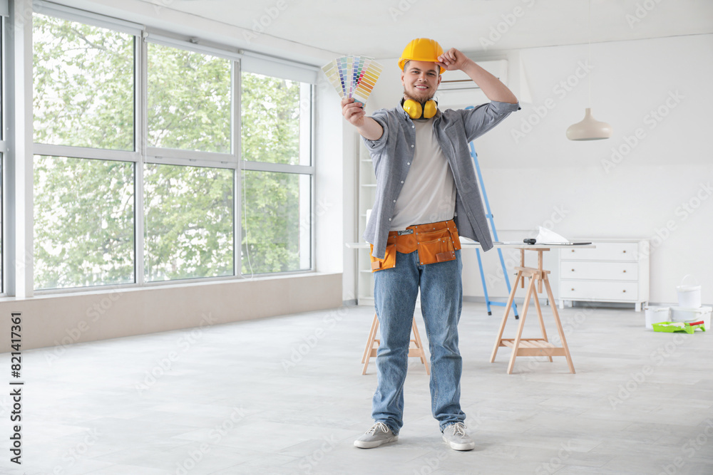 Male contractor with paint color palettes in room