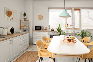 Sticker - Interior of stylish kitchen with dining table, chairs and lamp