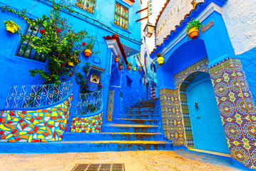 Chefchaouen, Morocco: Blue narow stairs with colourful walls and flowerpots into old walled city, or medina, North Africa