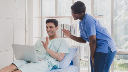 Portrait physical caucasian business man one person sick smile happy laying in bed looking and hand holding computer laptop working job successful while recuperating body in hospital clinic room