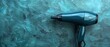 © nattapon98 - Stylish blue hair dryer against a textured teal background. Beauty and hair care product photography.