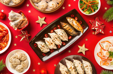Wall Mural - A table full of traditional Chinese New Year dishes, including dumplings and fish with ginger and lemon slices on a red background in a flat lay