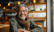 © Bartek - Happy mature man sitting in cozy cafe with warm lighting during daytime, smiling and relaxed, enjoying leisure time, concept of happiness, contentment, and relaxation