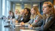 © LittleDreamStocks - Group of businesswomen attentively listening to presentation in conference room, showcasing professional meeting and corporate collaboration.