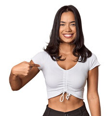Wall Mural - Young filipino woman person pointing by hand to a shirt copy space, proud and confident