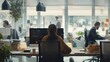 © JINGWEN - Enthusiastic modern office team collaborating innovatively in dynamic workspace