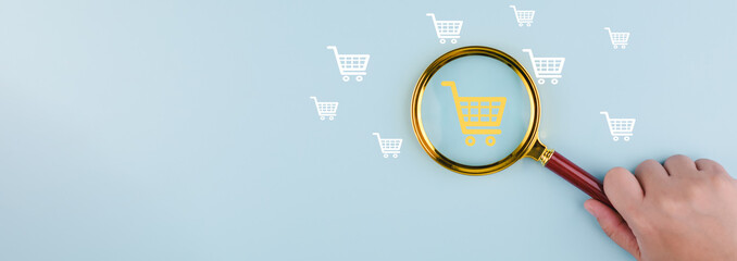 Wall Mural - Magnifying glass focus with online shopping concept, marketplace website with virtual interface of online Shopping cart part of the network, Online shopping business with selecting shopping cart.