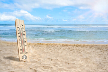 Wall Mural - Thermometer with hot temperature on the beach