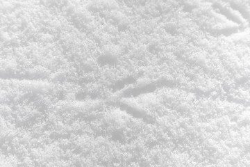 Footprints of birds on the snow close-up, background, texture