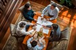 © Ilia Nesolenyi - Family discusses estate planning with legal documents around a wooden table