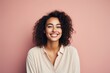 © Markus Schröder - Portrait of a grinning woman in her 20s smiling at the camera on solid pastel color wall