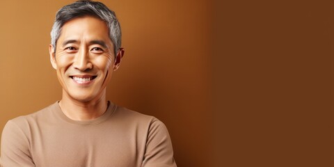 Brown Background Happy asian man. Portrait of older mid aged person beautiful Smiling boy good mood Isolated on Background ethnic diversity equality acceptance 