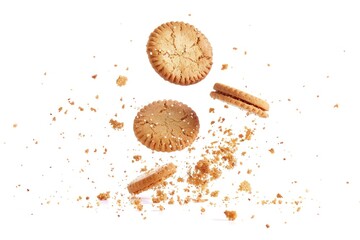 Aufkleber - Two cookies and cookie crumbs on a white surface, suitable for food and baking concepts