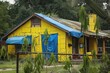 © Fotograf - A yellow house with a blue tarp on the roof. Suitable for real estate or construction concepts