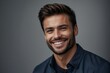 © Bella - Portrait_of_a_handsome_man_smiling_against_grey_background